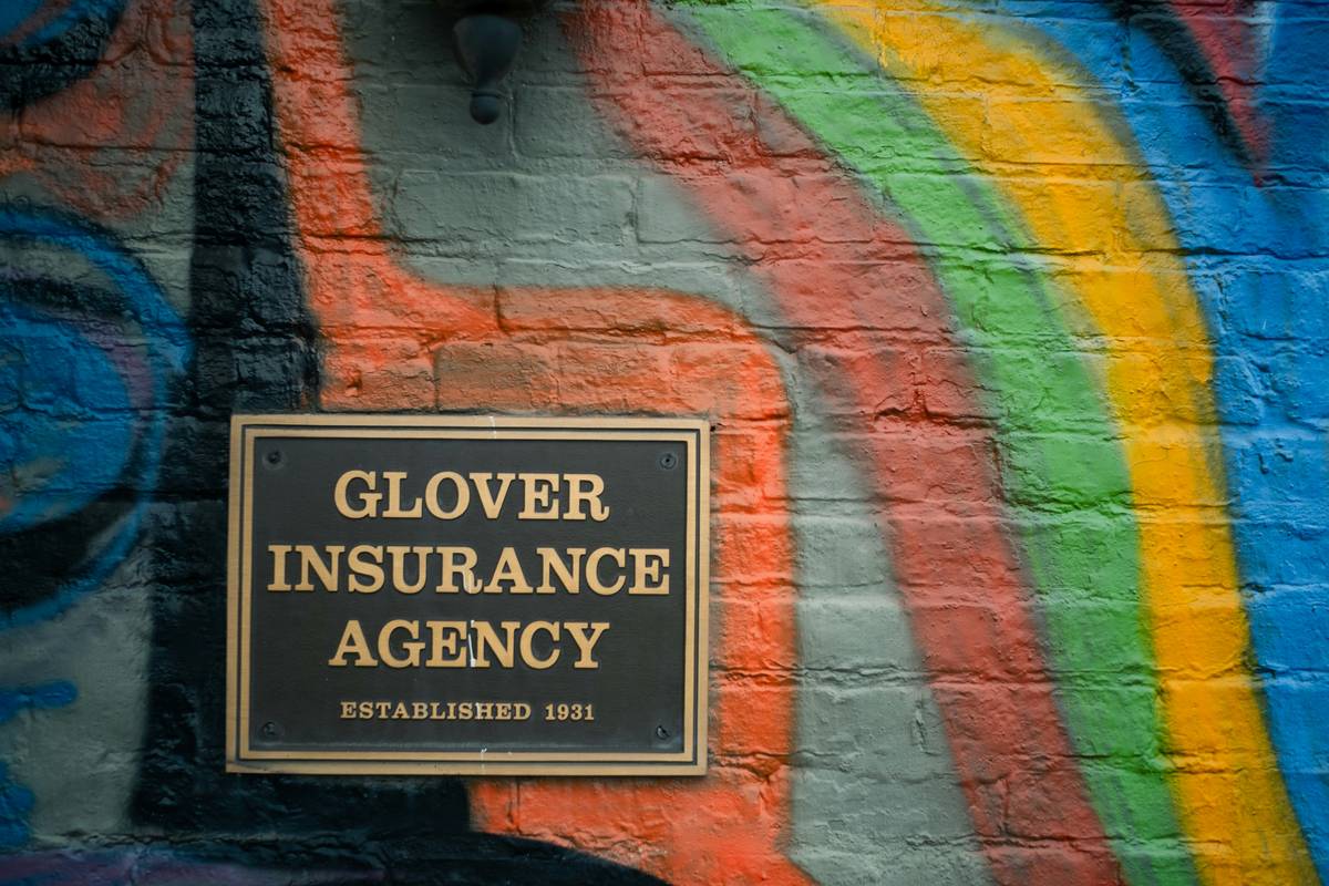 Dry cleaner reviewing boiler insurance policy documents with agent from Damico Insurance Agency